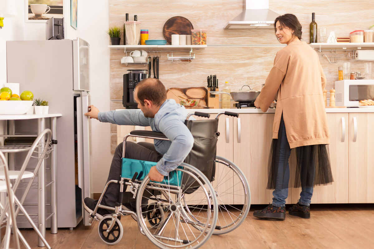 Carer supporting NDIS participant outdoors – Aussie Community Care, Melbourne.